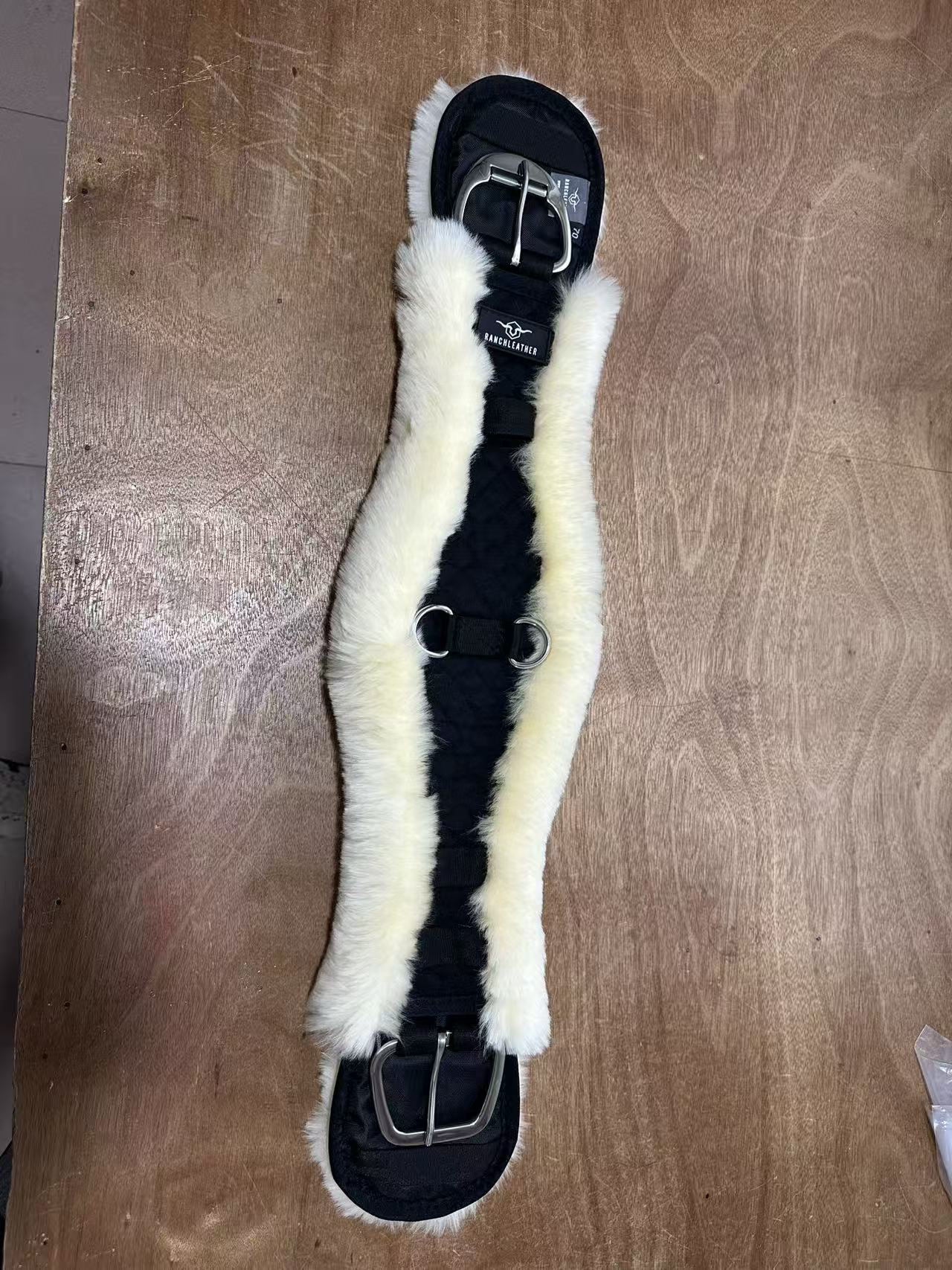 Front view: black outer construction with natural-colored sheepskin lining.